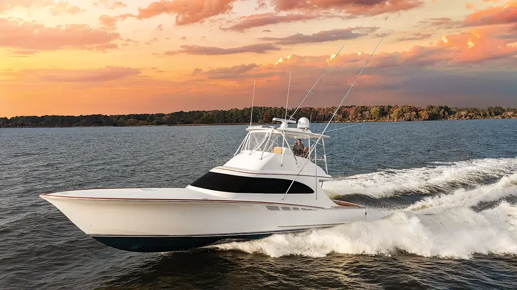 Sport-fishing boat running offshore at sunset